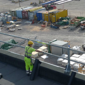 Worker on a roof wearing a hard hat